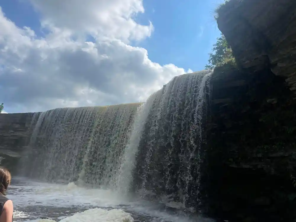 Dramatic waterfall flowing over dark columnar rock