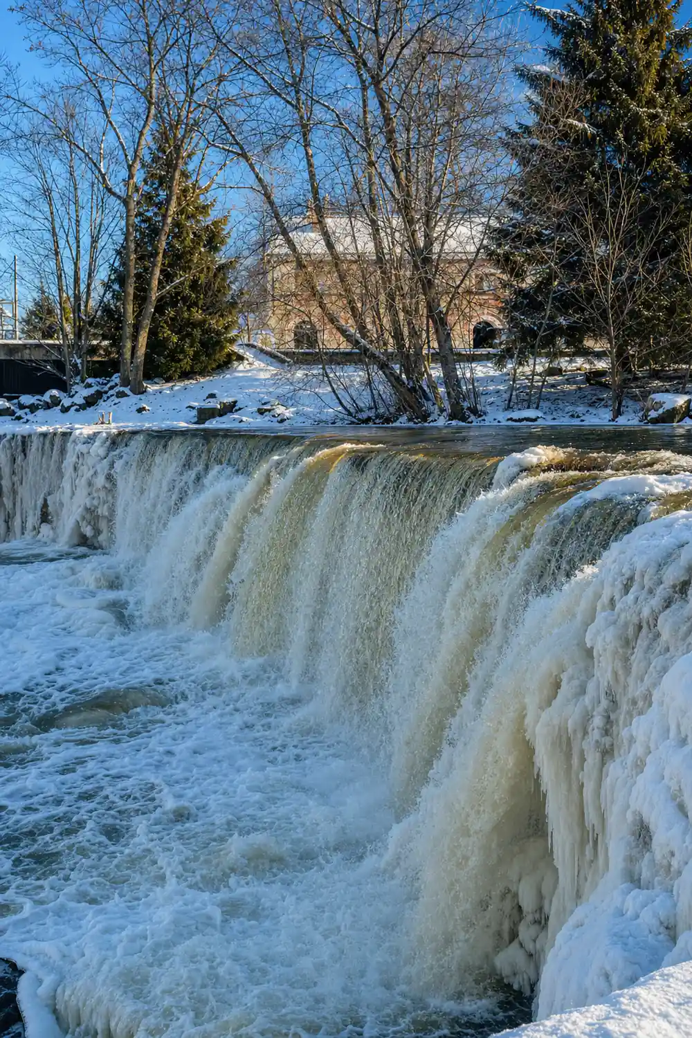 Frozen waterfall with ice formations in winter