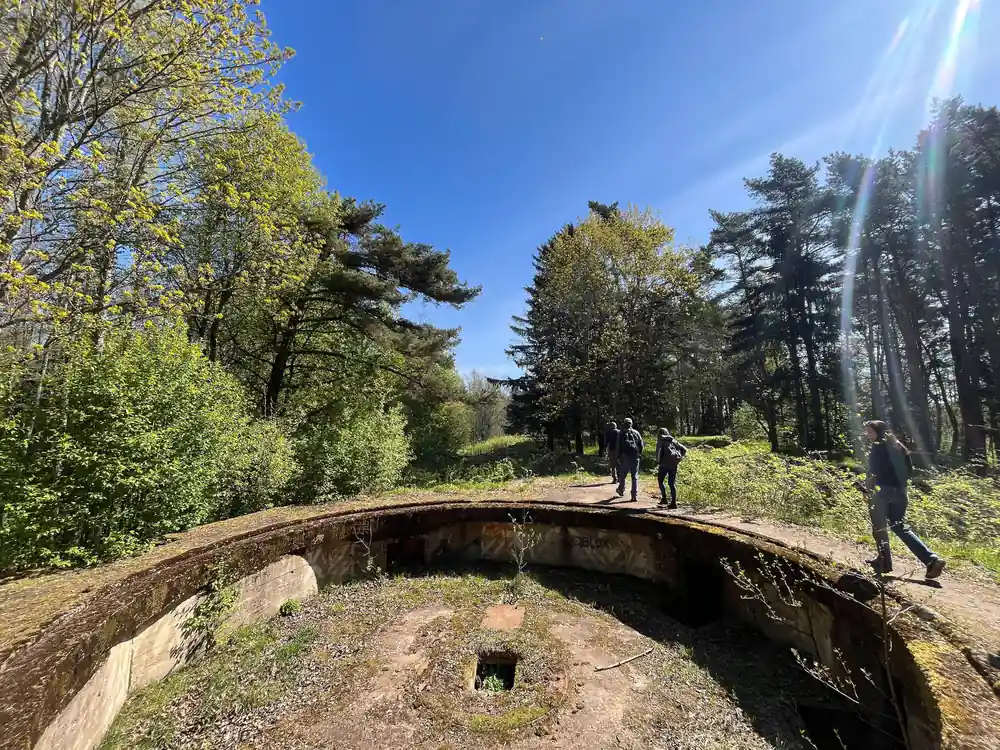 People walking on concrete tunnel or bunker structure