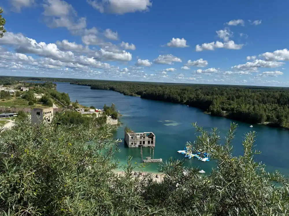 Quarry lake with turquoise water and forested banks
