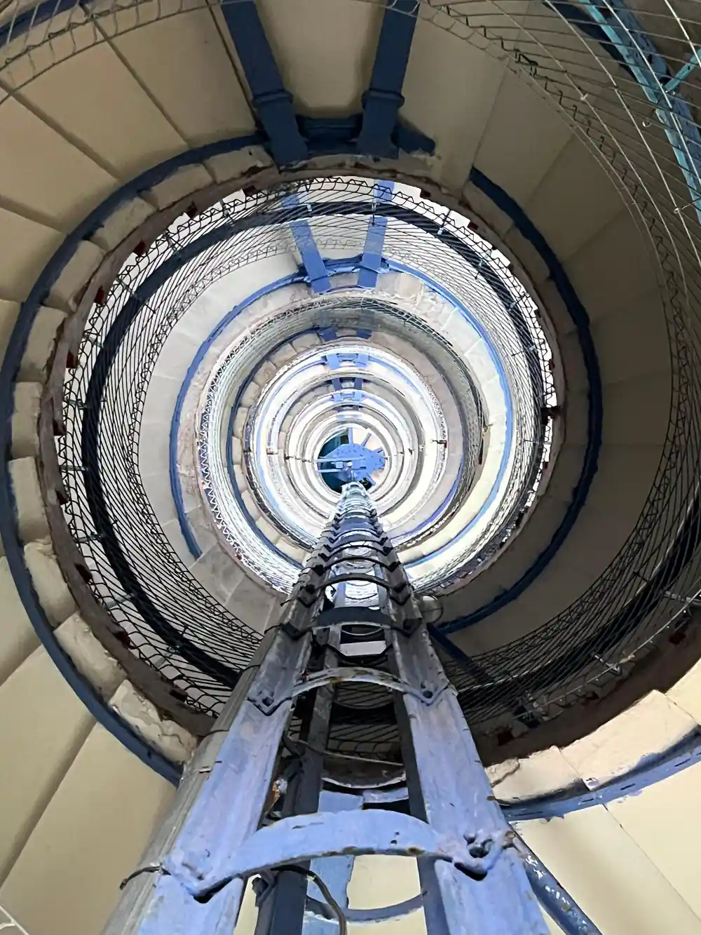 Spiral staircase viewed from above through circular tower